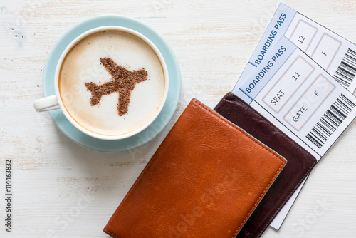Boarding passes, passports and coffee with aircraft made of cinnamon