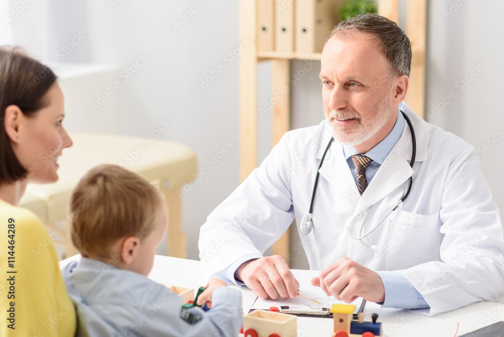 Little boy with his mother at paediatrician on consultation Little boy with his mother at paediatrician on consultation