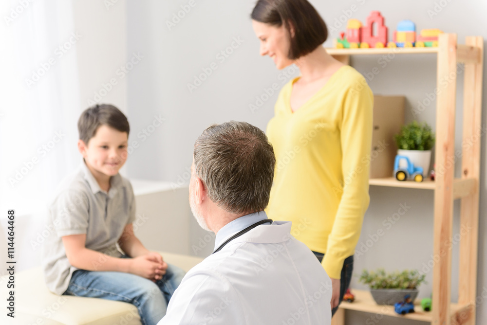 Young boy with his pediatrician and mother Young boy with his pediatrician and mother