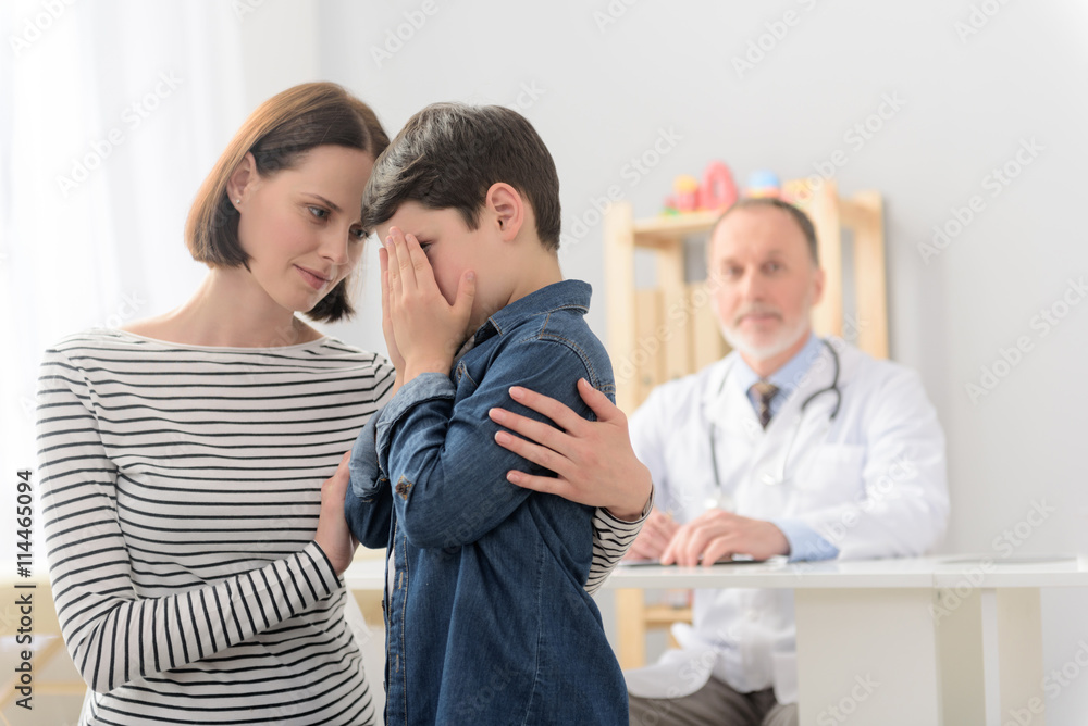 Mother and son visiting pediatrician Mother and son visiting pediatrician