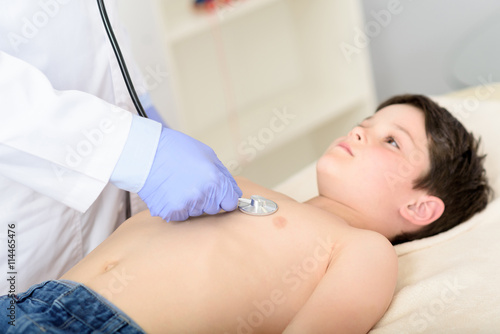 Pediatrician doing checkup on young boy