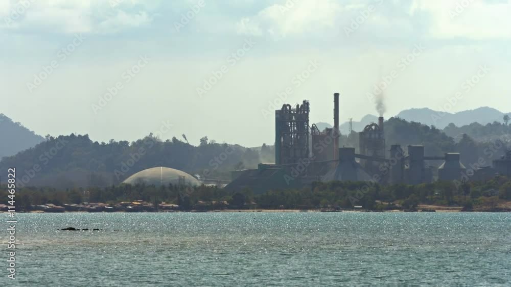 UltraHD video - Steam rises from a stack atop an industrial complex which provides employment to local people living in this coastal community. UltraHD video - Steam rises from a stack atop an industrial complex which provides employment to local people living in this coastal community.