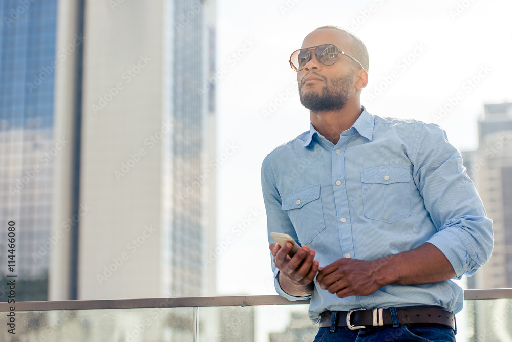 Afro American businessman with gadget