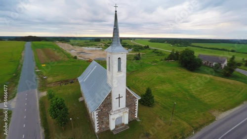 Old catholic church building. Aerial footage. Summer nature landscape.