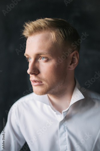 Young blonde dreamy man studio portrait © katie_martynova