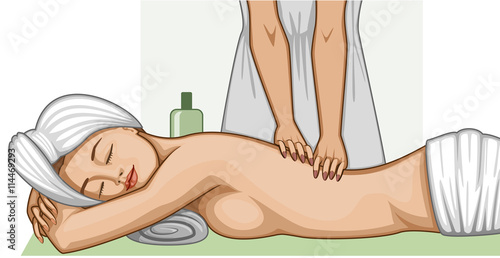 A relaxed woman in towels lying on her stomach having a back massage
