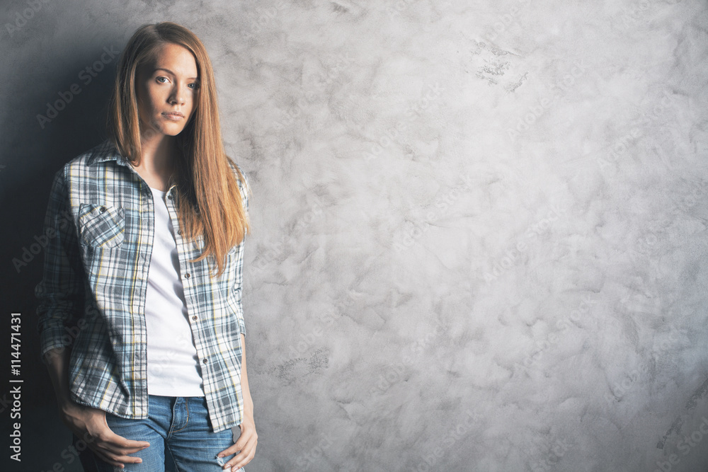 Attractive woman against concrete wall Attractive woman against concrete wall