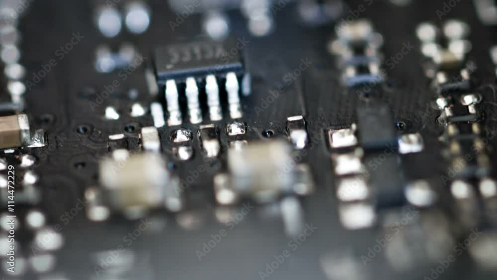 Video FullHD (1920x1080) - Close-in, macro zoom shot of the interior motherboard of a computer with integrated circuits and other components, soldered into place.