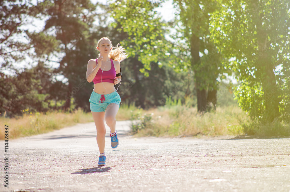 Young girl running in the morning in city park. Healthy fitness