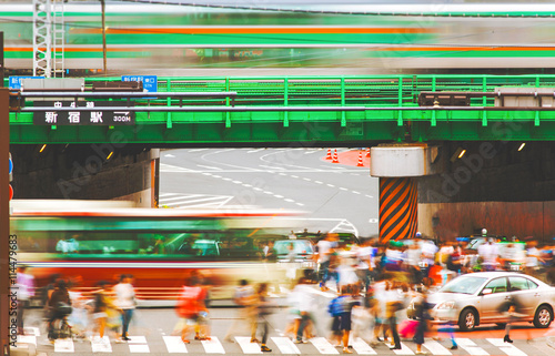 Motion blurred crowds crossing a busy intersection in Tokyo