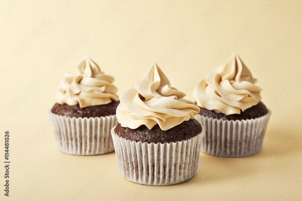 Tasty cupcakes on color background Tasty cupcakes on color background