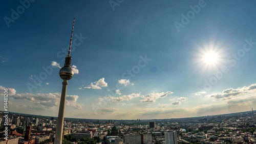 Perfect Skyline aerial of Berlin with beautiful sun and some clouds. Summer time in the late afternoon. Beautiful lens flare blue and yellow colors. Hyper lapse. Fernsehturm, TV-Tower photo