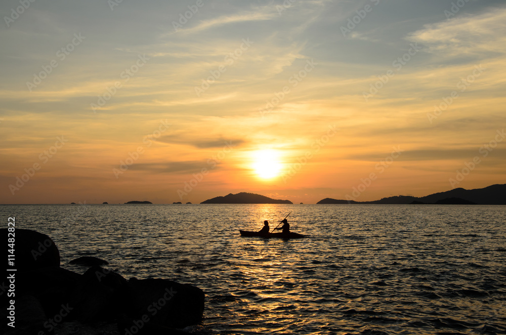 Silhouette people kayak in the sea with summer sunset sky background at Li Pe island Thailand.