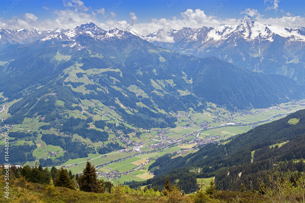 Bird view of the Zillertal valley village surrounded by mountains with snow during summer in Tyrol, Austria, Europe 