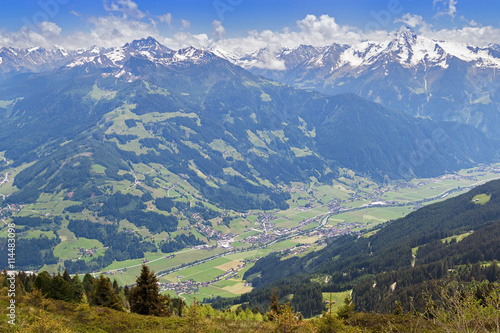 Bird view of the Zillertal valley village surrounded by mountains with snow during summer in Tyrol, Austria, Europe  © sasimoto