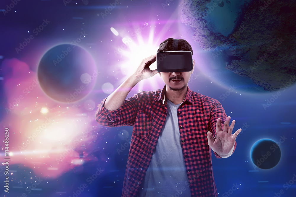Young asian man wear VR headset get into virtual reality world Young asian man wear VR headset get into virtual reality world