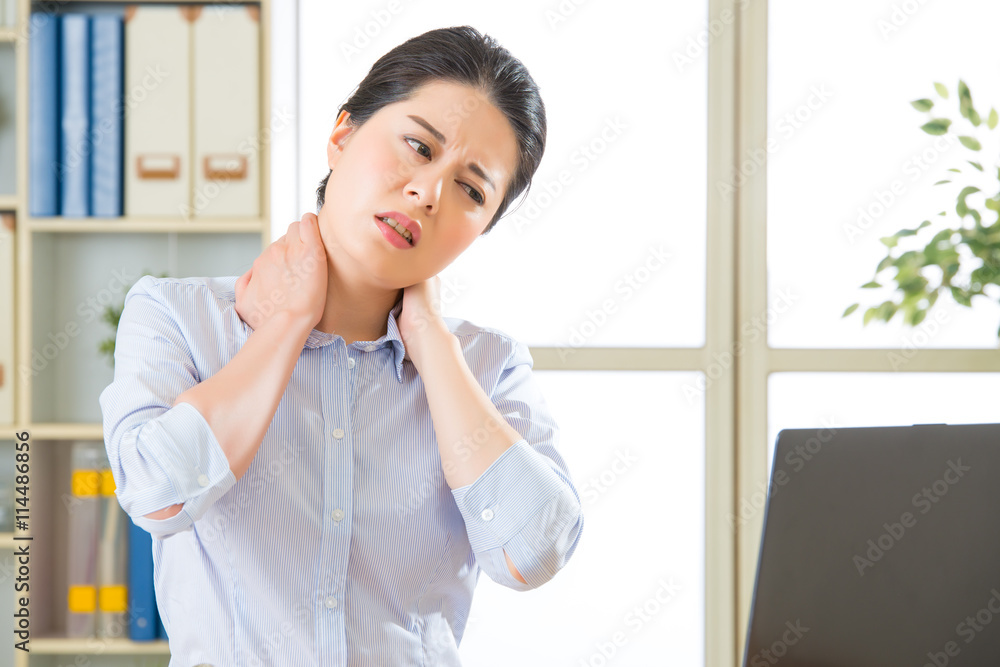 Young asian business woman with pain in neck Young asian business woman with pain in neck