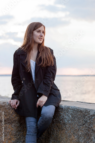 Girl sitting near river