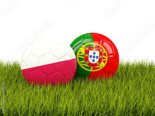 Portugal and Poland soccer balls on grass