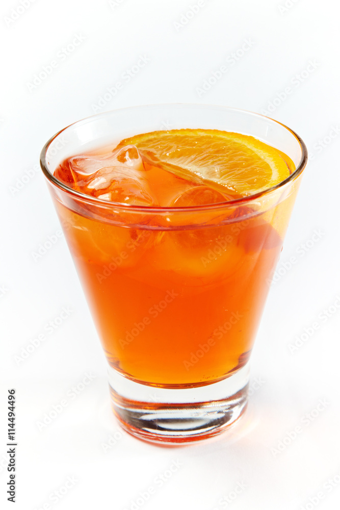 Fototapeta premium Orange cocktail with ice in a glass isolated on white background