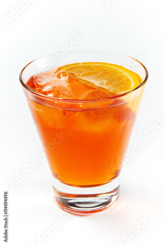 Orange cocktail with ice in a glass isolated on white background