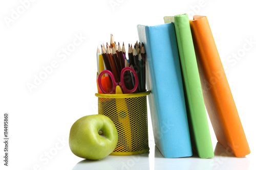 a stack of books in multi-colored covers near to Apple and pencil box with school equipmentr on a white isolated background photo