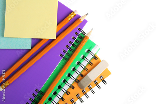 colorful notebooks with stickers and pencils with an eraser on white isolated background