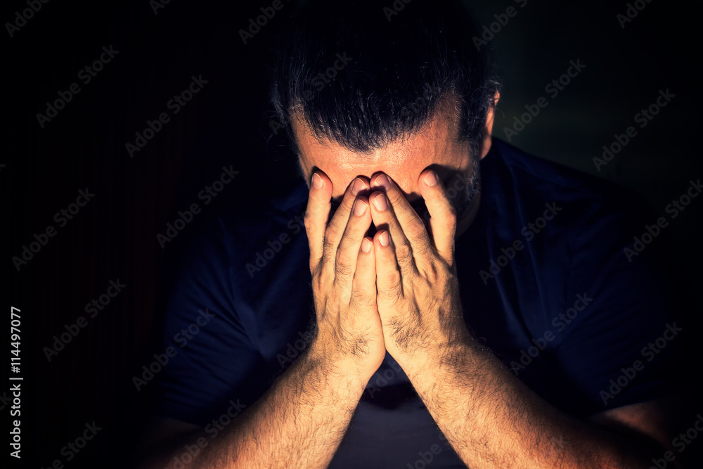 Depressed, sad man covering his face with his hands Depressed, sad man covering his face with his hands