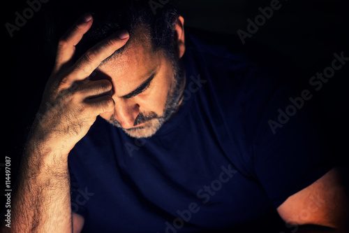 Fotografija Worried lonely man with one hand on his forehead