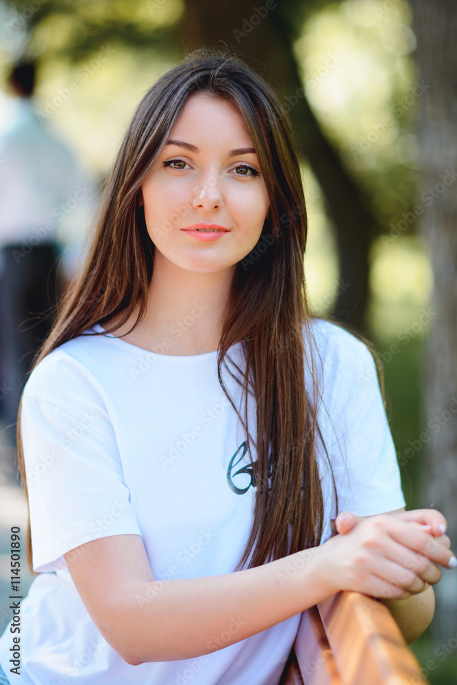 Woman smiling in a park and looking at camera Woman smiling in a park and looking at camera