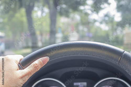hand of woman driving car