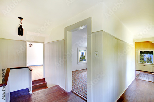 Upstairs hallway with hardwood floor and staircase.