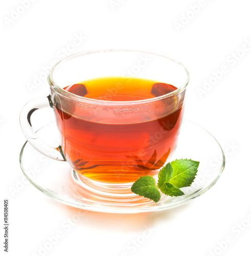 Transparent cup of tea and mint leaves on white