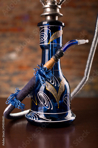 Eastern hookah on wood table photo