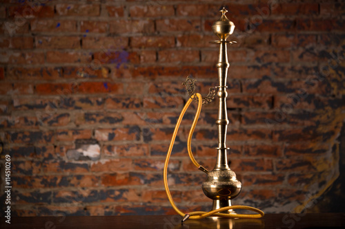 Eastern hookah on wood table photo