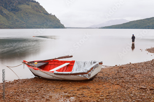 Old fishing craft anchored on the beach Puyuhuapi Fjord, Patagon photo
