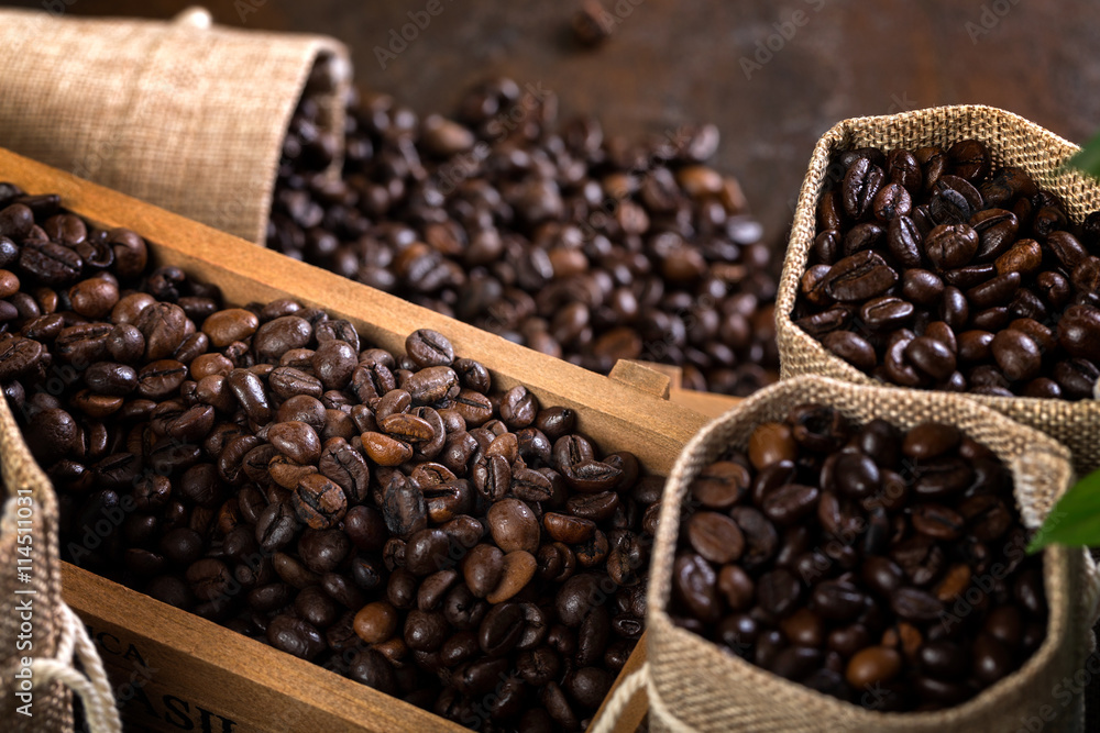 Jute bags and wooden containers filled with cofee beans Jute bags and wooden containers filled with cofee beans