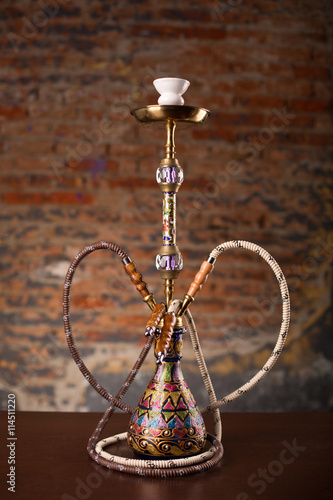 Eastern hookah on wood table photo