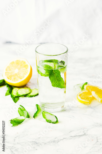 Lemonade with mint and ice in glass, morning, summer drink