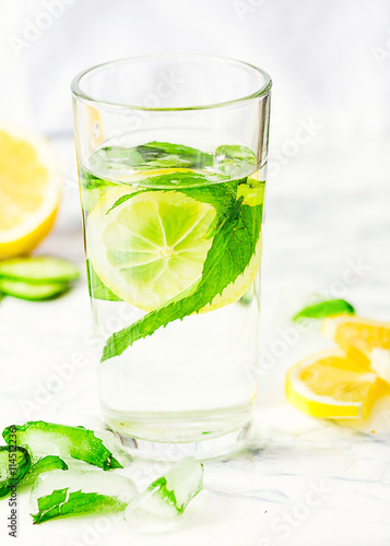 Lemonade with mint and ice in glass, morning, summer drink