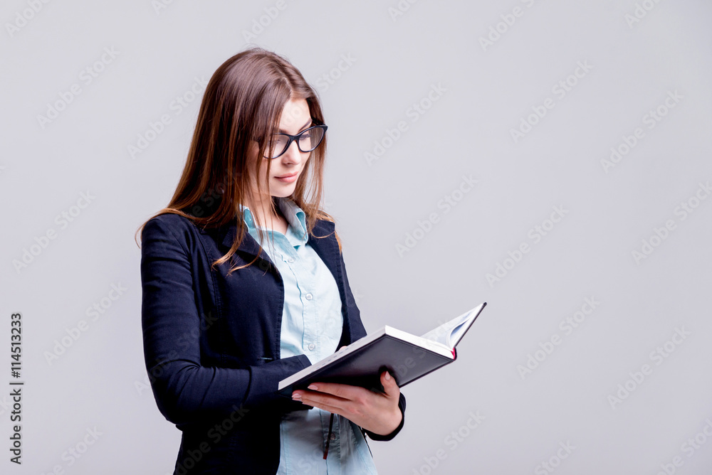 Business woman in the office on the gray background Business woman in the office on the gray background