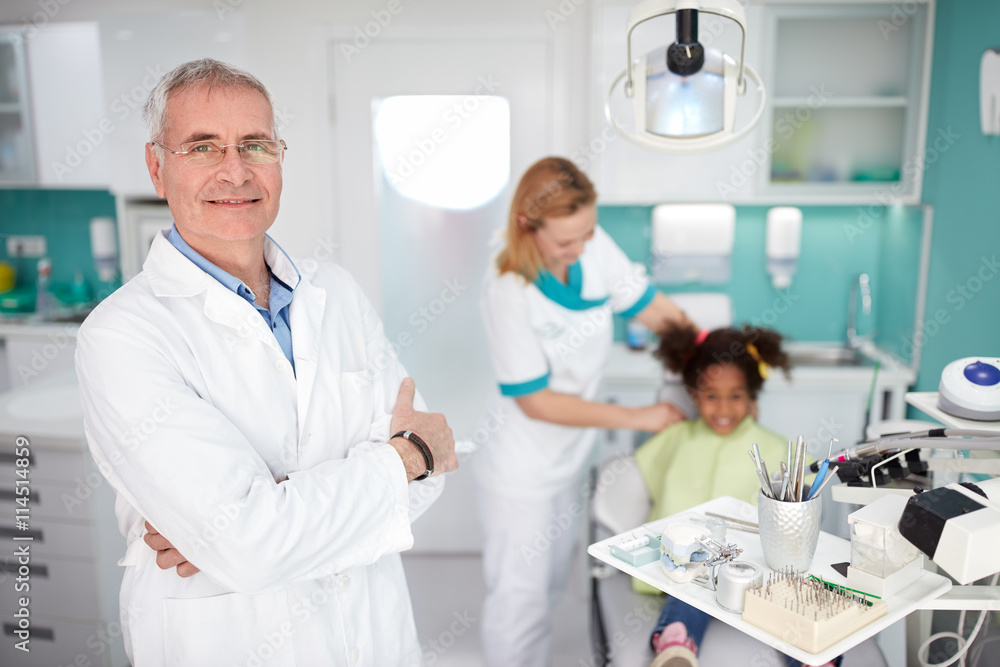 Dentist in dental clinic with assistant before starting work