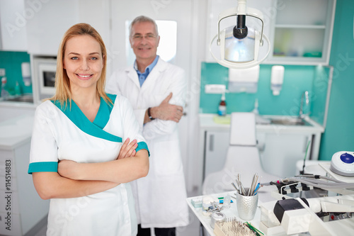 Portrait of dental assistant with dentist in dental clinic