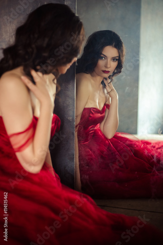 portrait of sensual woman in a long gorgeous red dress
