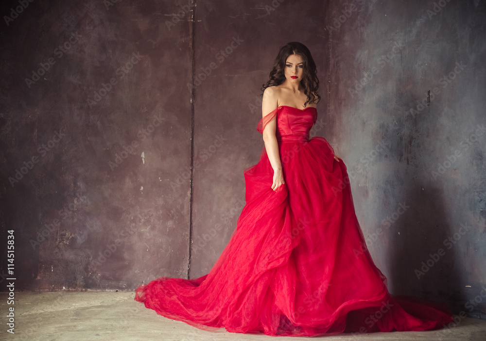 portrait of sensual woman in a long gorgeous red dress