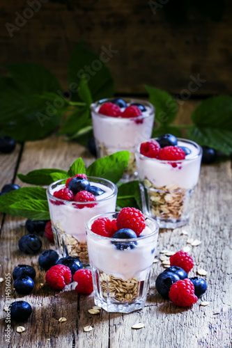Sweet berry dessert with oatmeal, yogurt, blueberries and raspbe