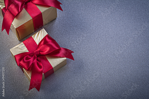 Wrapped giftboxes on grey background copy space holidays concept