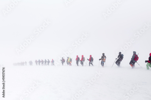 Elbrus, Caucasus mountains, Russia. A huge group of climbers descends from the Elbrus in the fog. The concept of climbing the mountain in a snow storm