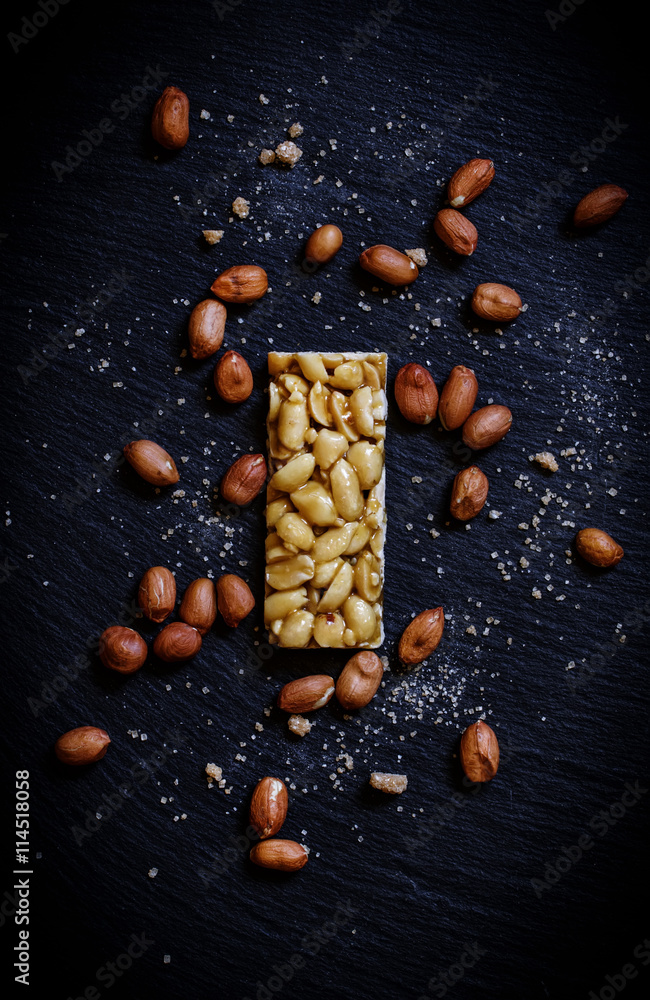 Harmful dessert peanuts in caramel, scattered brown sugar, dark Harmful dessert peanuts in caramel, scattered brown sugar, dark