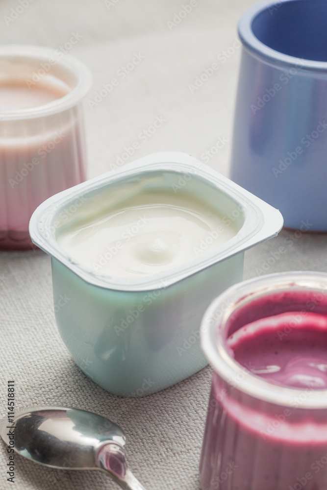 Yogurts assortment in plastic bowls on light cloth background. Natural and fruit healthy, diet, gourmet dessert for granola breakfast. Sweet yoghurts closeup.
Yogurts assortment in plastic bowls on light cloth background. Natural and fruit healthy, diet, gourmet dessert for granola breakfast. Sweet yoghurts closeup.